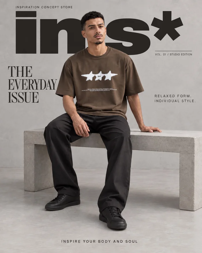 Fashion editorial with a seated model in a brown oversized T-shirt.