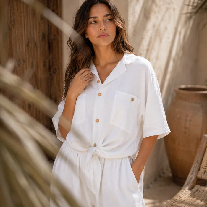 White summer shirt with textured fabric and wooden buttons.