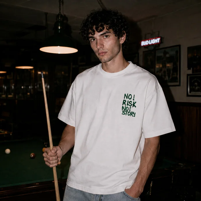 Man in a white T-shirt holding a pool cue.