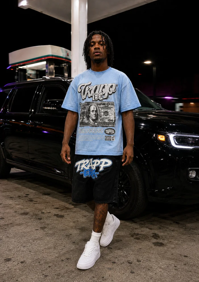 Man in a blue T-shirt walking at a gas station.
