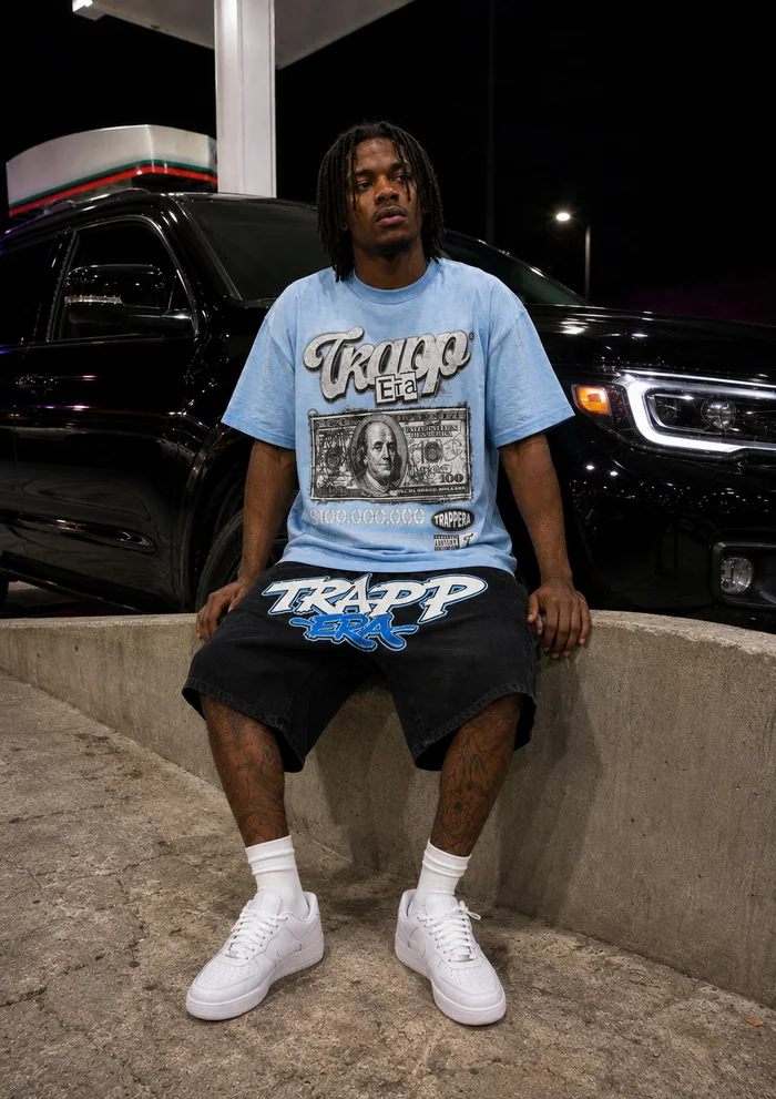 Man in a blue T-shirt seated at a gas station.